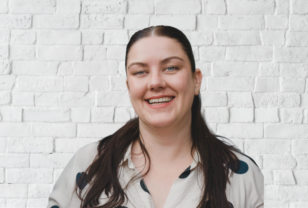 Woman smiles at the camera. She has long dark hair.