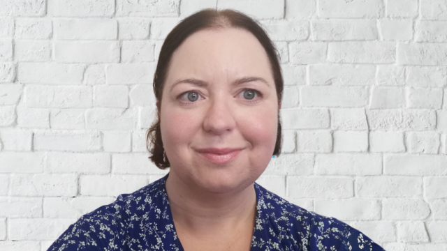 Woman smiles at camera.