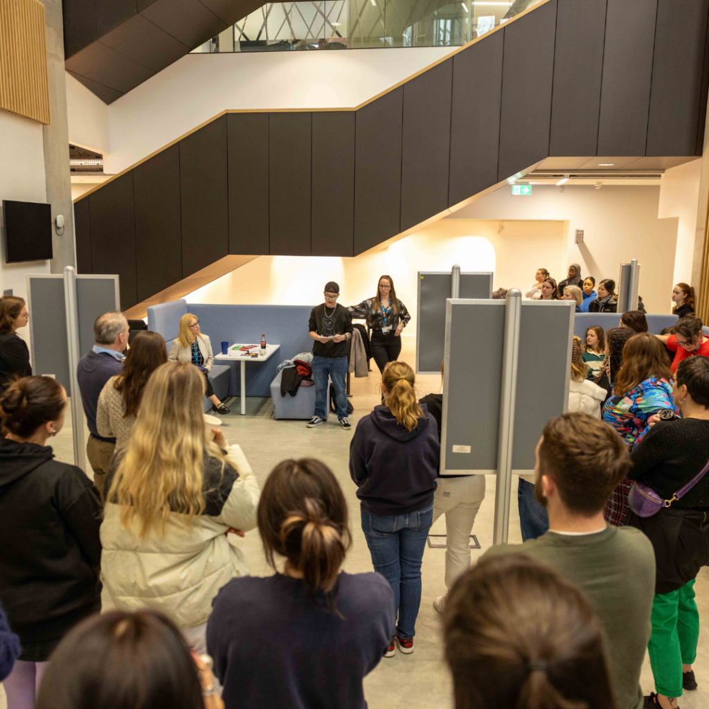 A young person speaking to a crowd at an event.