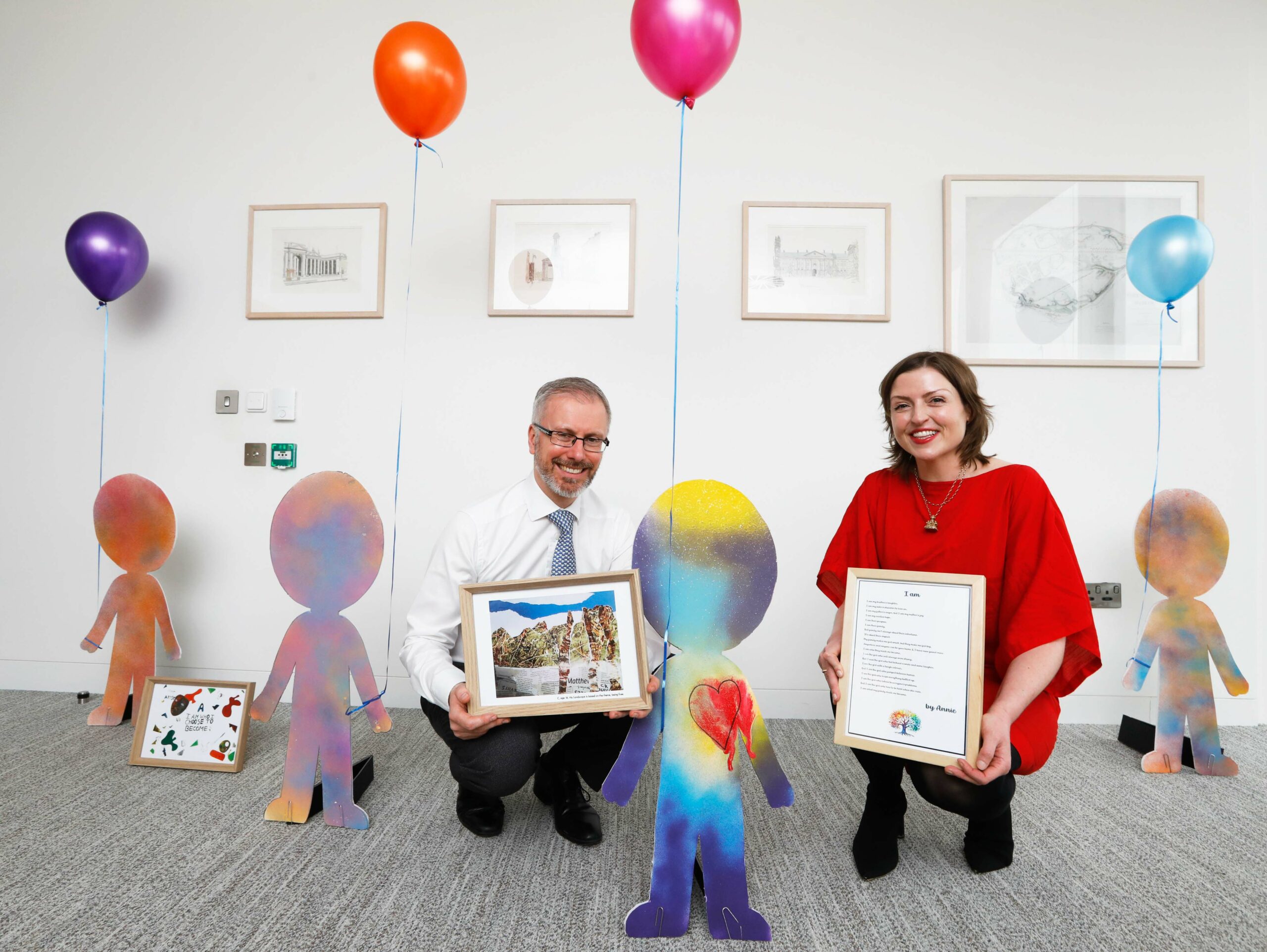 Minister for Children, Roderic O'Gorman, accepting artwork and poetry by children and young people in care from EPIC CEO Marissa Ryan