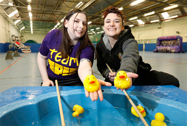 Image of members of our Youth Council members, Andrea and Reece, holding two rubber ducks towards the camera