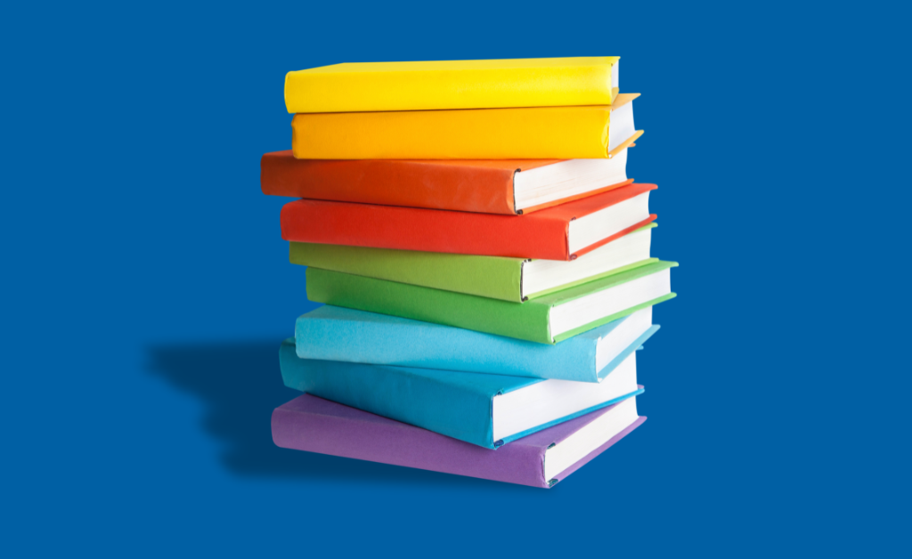 A pile of colourful books against a deep blue background